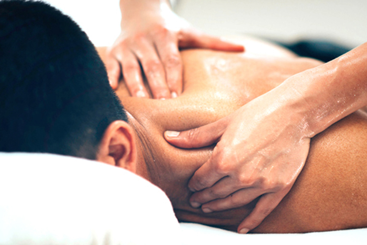 A skilled massage specialist at Glamour Spa Islamabad expertly applies aromatic oils while performing a therapeutic shoulder massage, promoting relaxation and relieving tension in a serene spa environment.