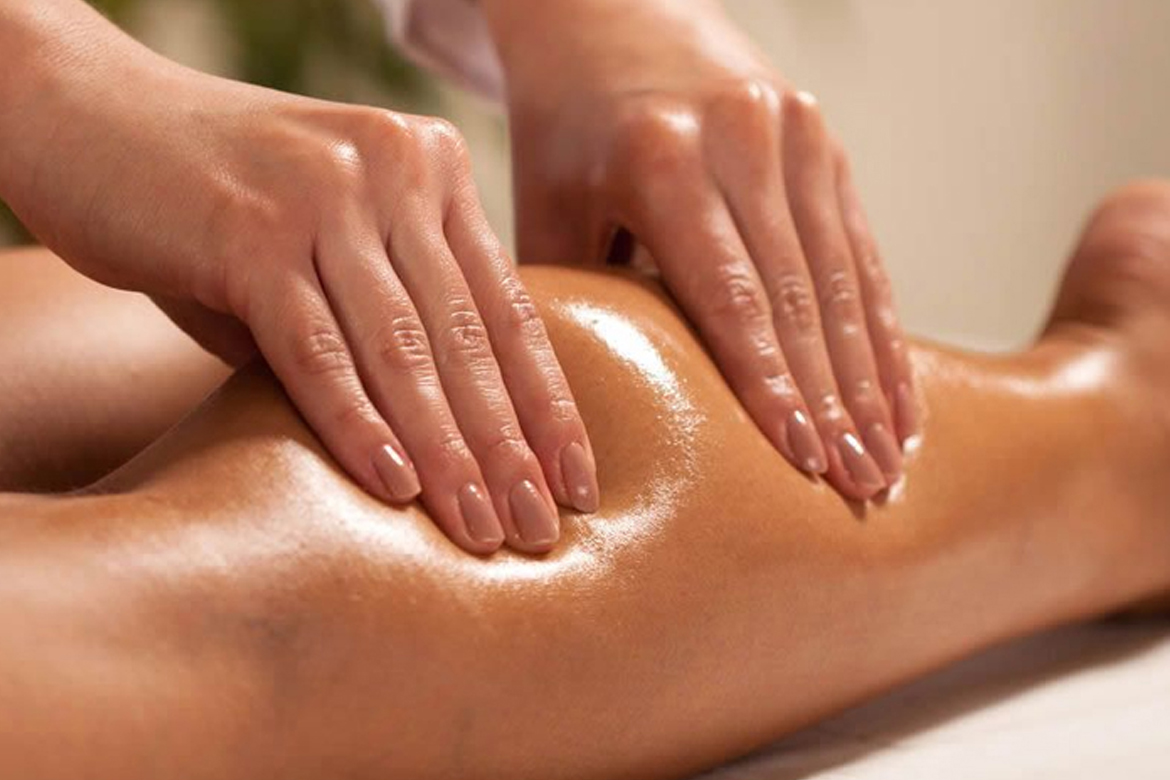 A massage expert at Glamour Spa Islamabad performing a Swedish massage on a client's legs, using professional techniques to enhance relaxation and circulation.